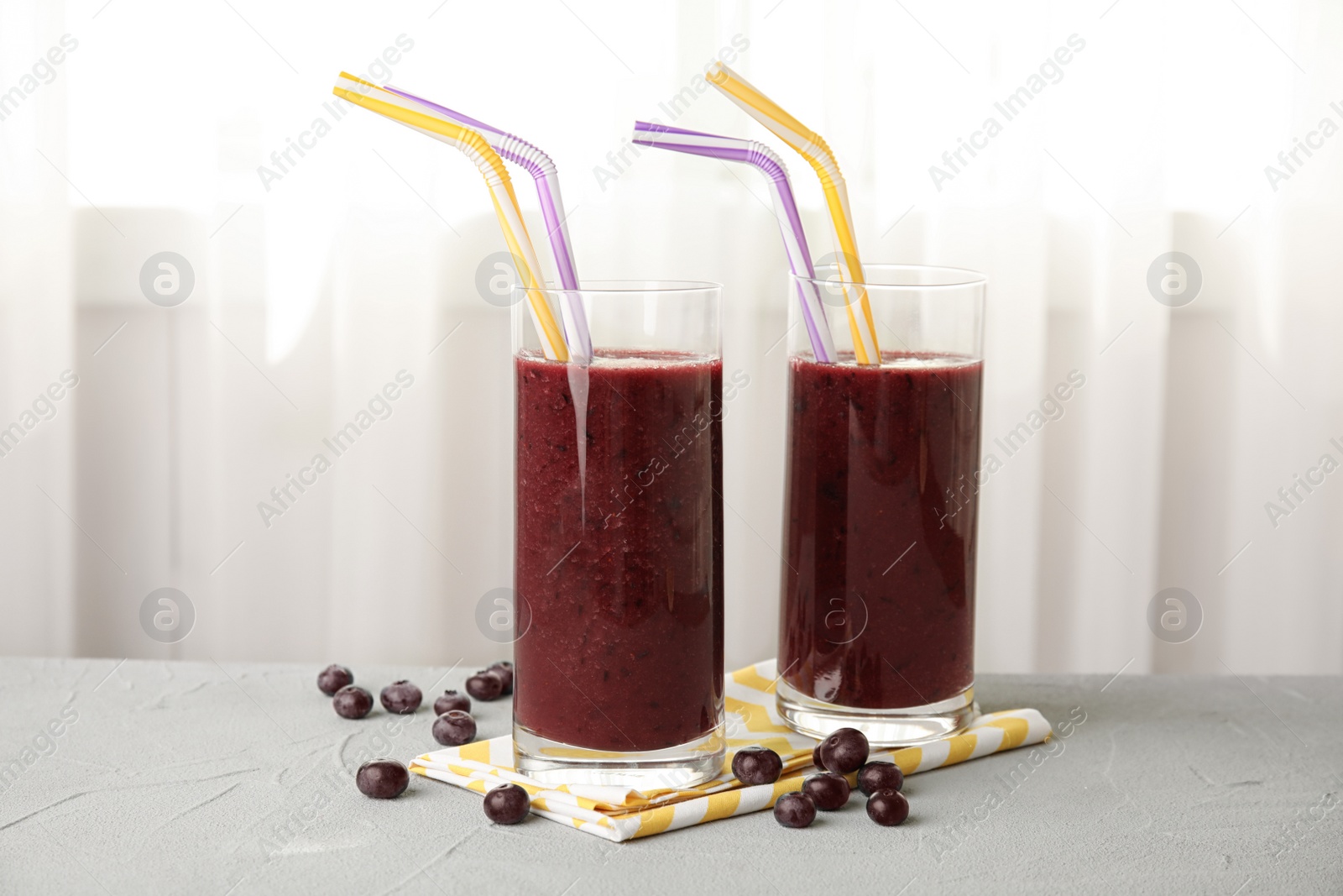 Photo of Glasses with delicious acai smoothie on table