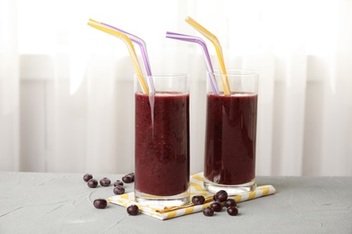 Photo of Glasses with delicious acai smoothie on table