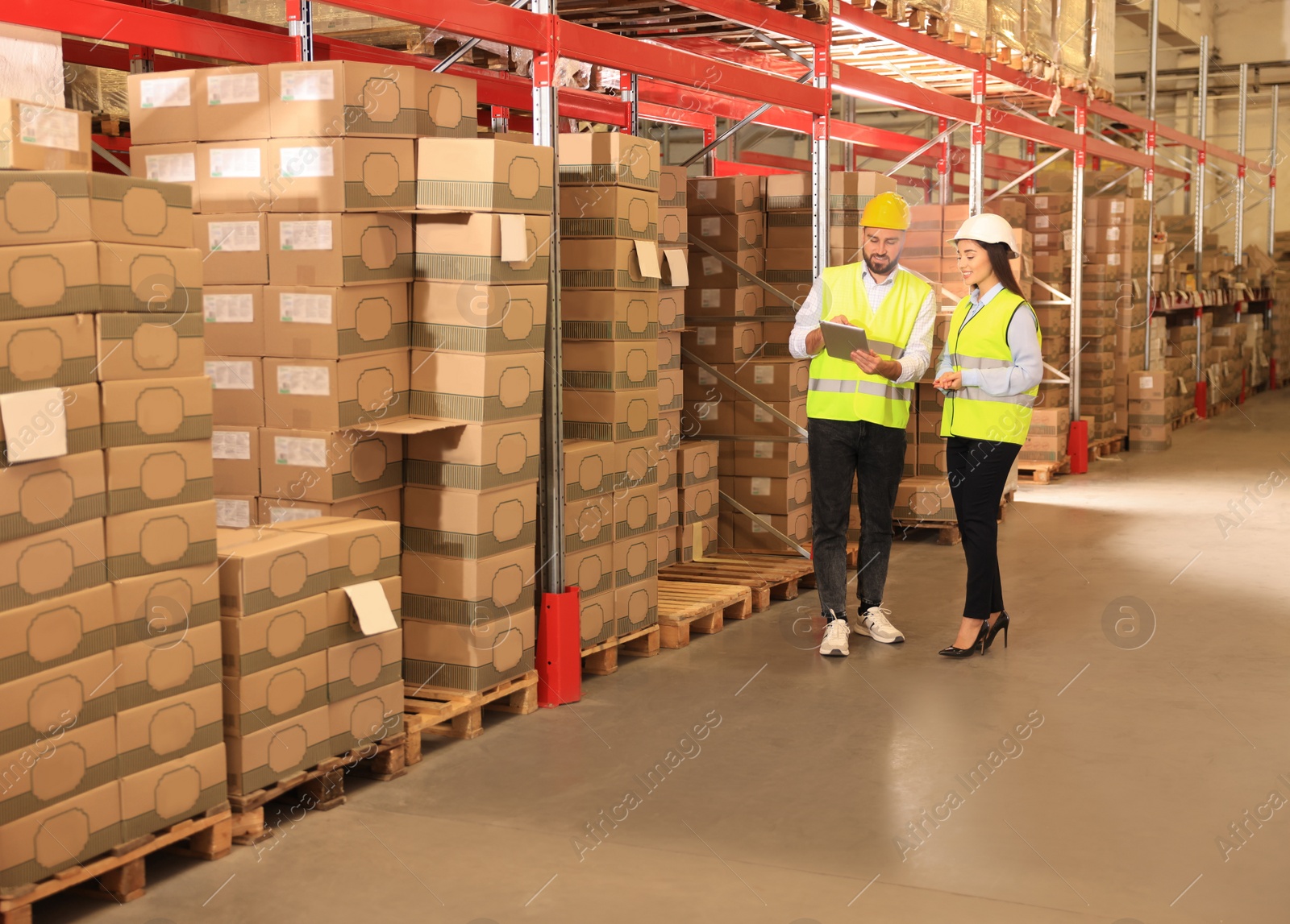 Image of Manager and worker at warehouse. Logistics center