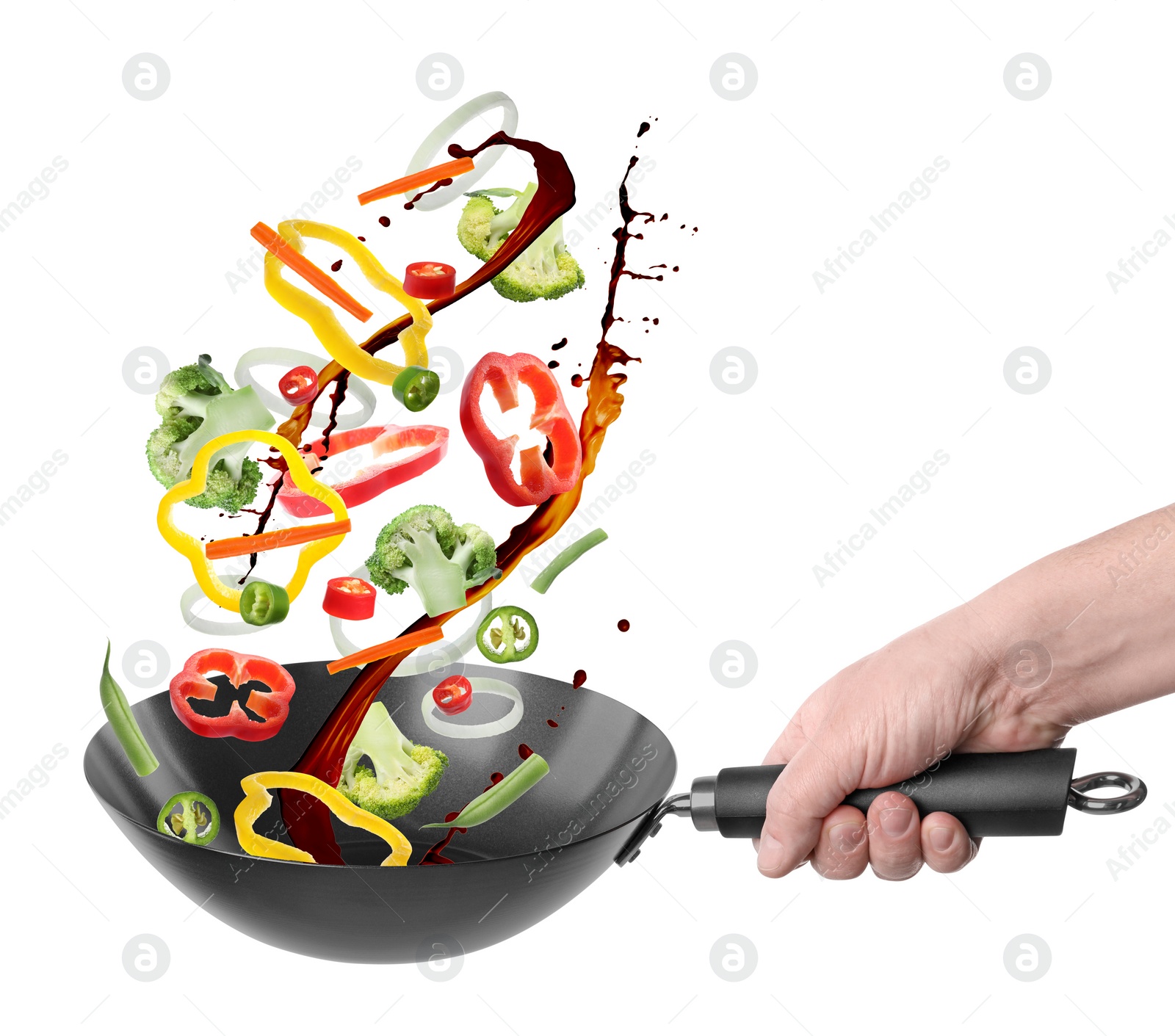 Image of Man tossing ingredients in wok on white background, closeup