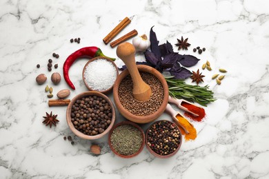 Flat lay composition with mortar and different spices on white marble table