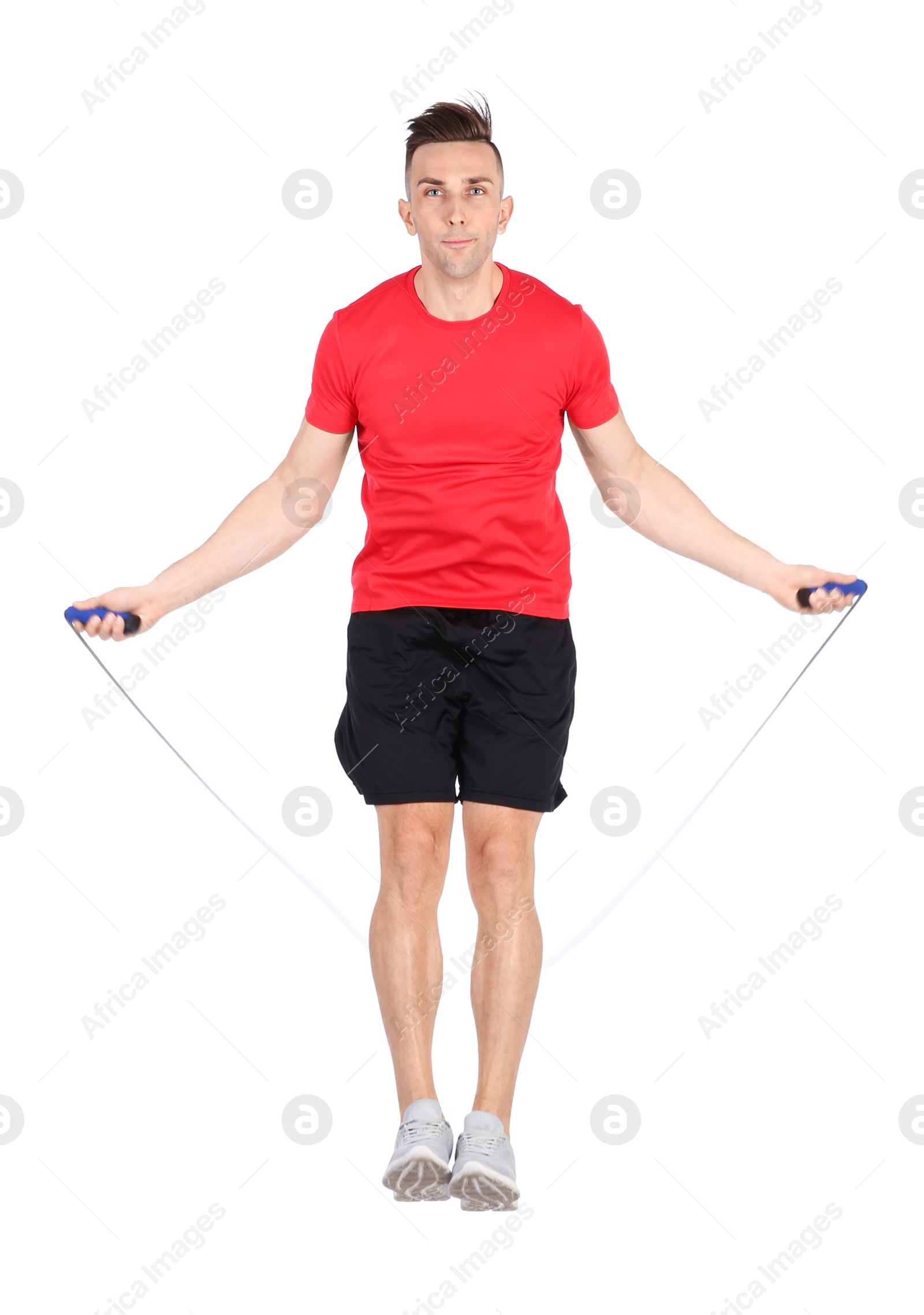 Photo of Full length portrait of young sportive man training with jump rope on white background