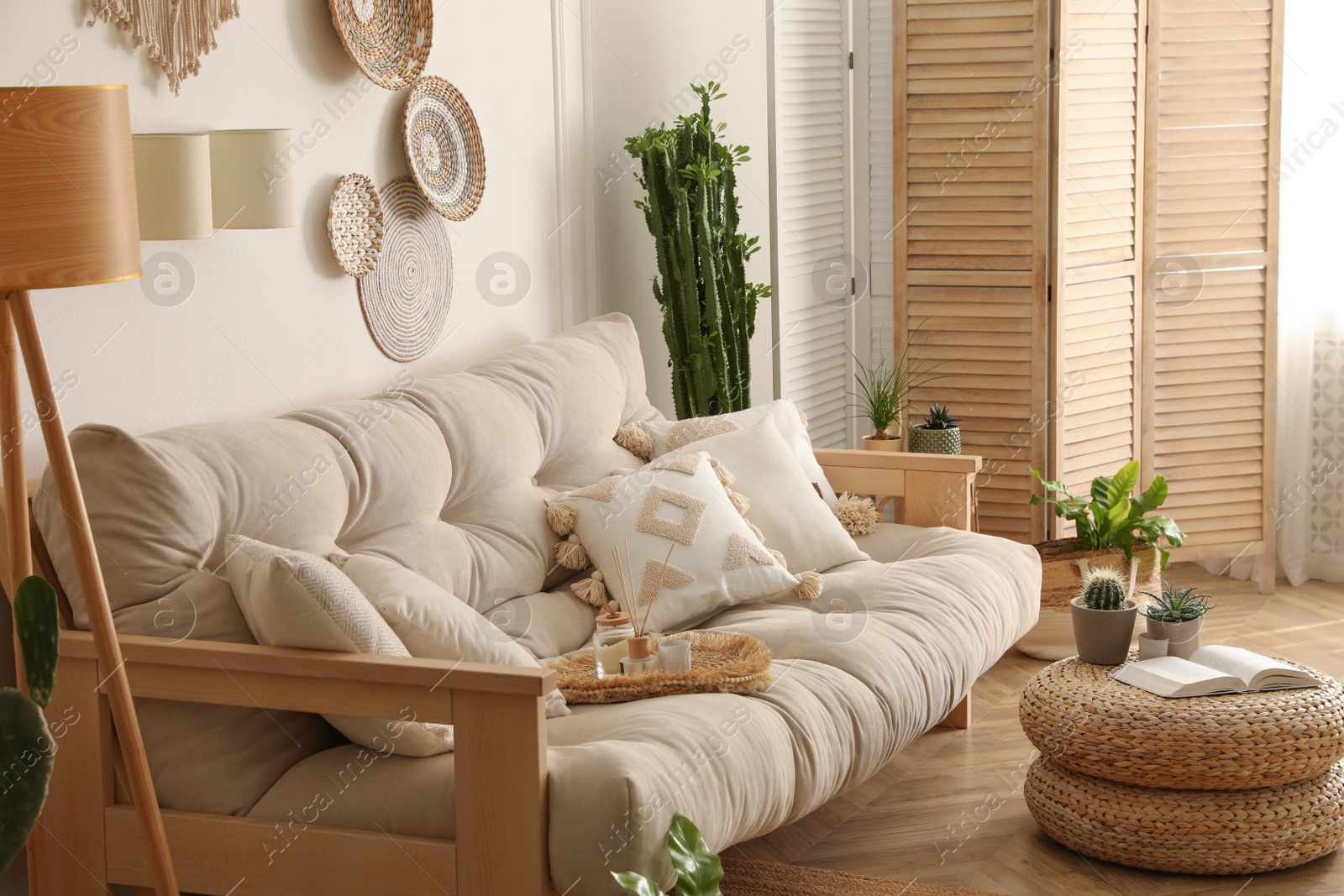 Photo of Stylish living room interior with comfortable wooden sofa and beautiful houseplants