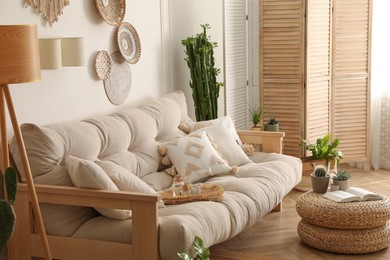 Photo of Stylish living room interior with comfortable wooden sofa and beautiful houseplants