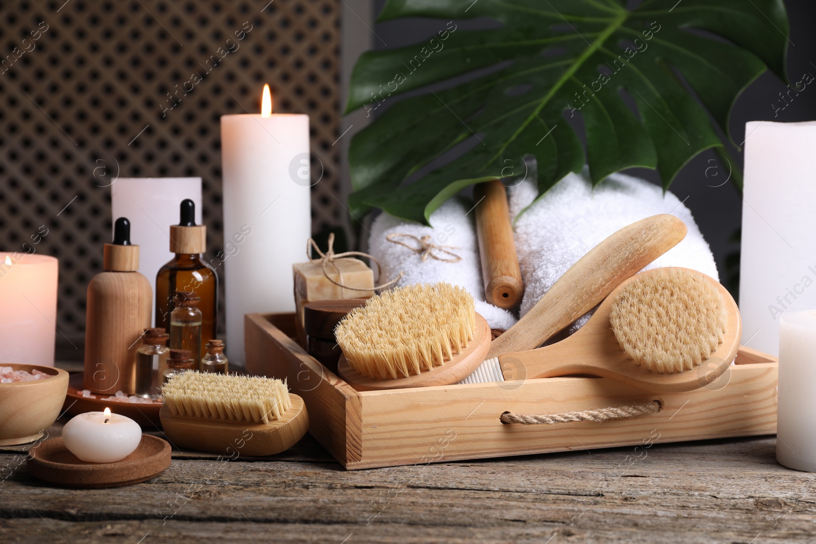 Photo of Composition with different spa products and burning candles on wooden table