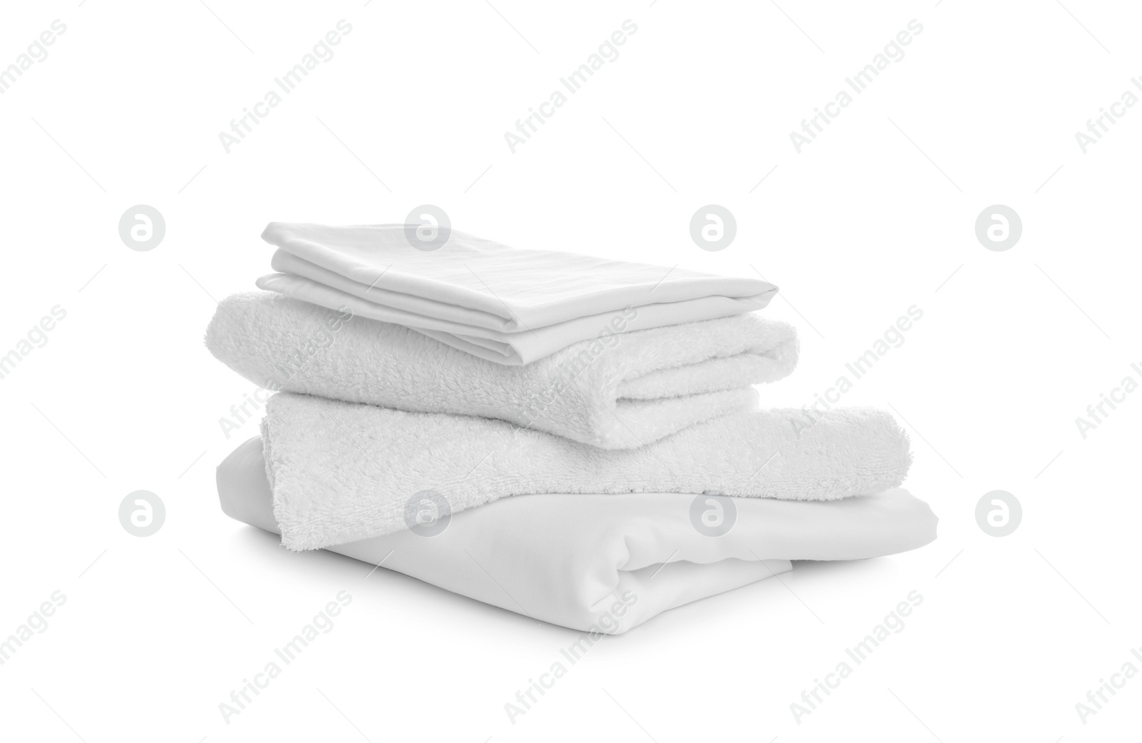 Photo of Stack of towels and bedding on white background