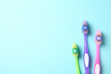 Photo of Flat lay composition with manual toothbrushes on color background