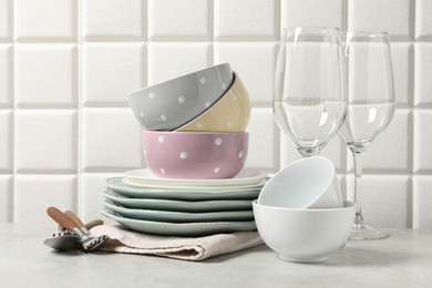 Photo of Beautiful ceramic dishware, glasses and cutlery on light grey table