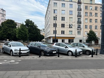 Different modern cars parked on city street