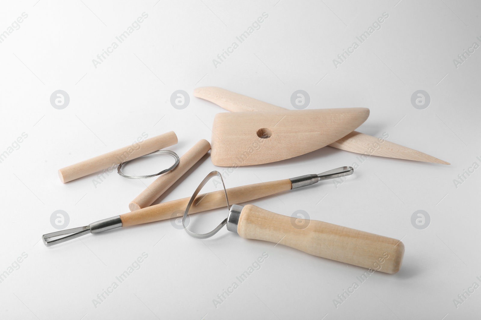 Photo of Set of clay modeling tools on white background