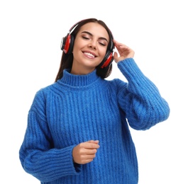 Young woman listening to music with headphones on white background