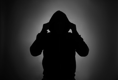 Photo of Silhouette of anonymous man on dark background