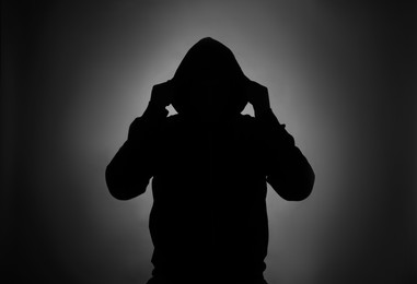 Silhouette of anonymous man on dark background