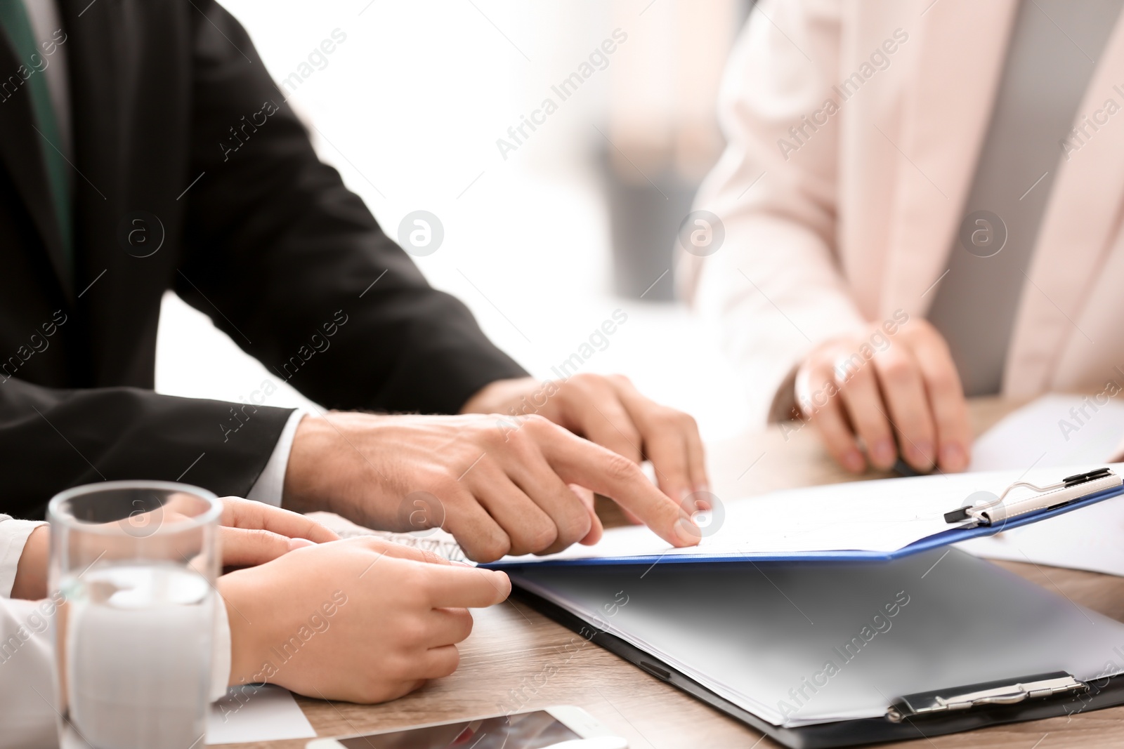 Photo of Young consultant working with clients in office