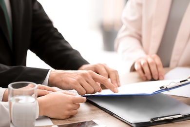 Young consultant working with clients in office