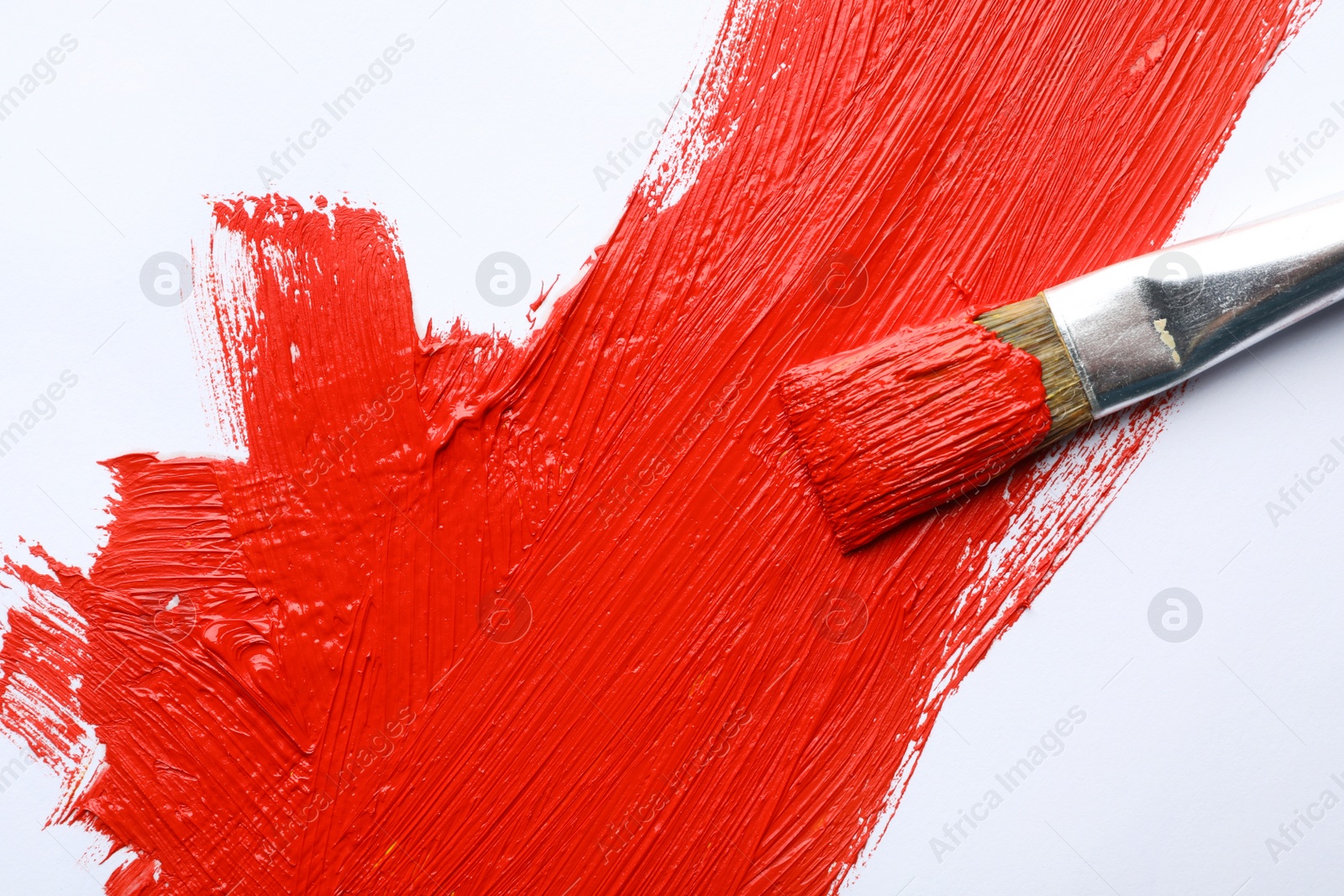 Photo of Paint stroke and brush on white background, top view