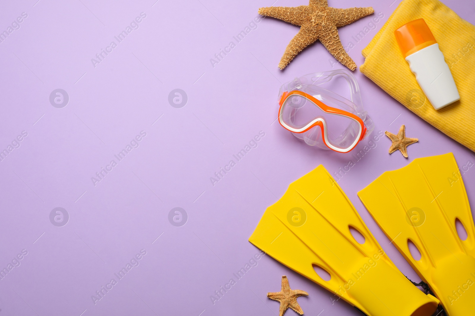 Photo of Flat lay composition with different beach objects on violet background, space for text