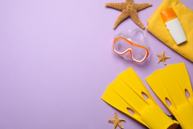 Flat lay composition with different beach objects on violet background, space for text