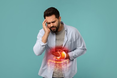 Man suffering from stomach ache on light blue background. Illustration of unhealthy gastrointestinal tract