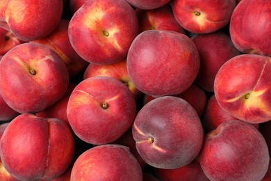 Photo of Delicious ripe peaches as background, top view