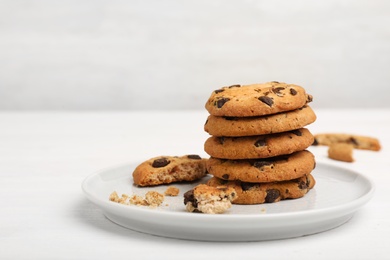 Photo of Plate with tasty chocolate cookies on light table