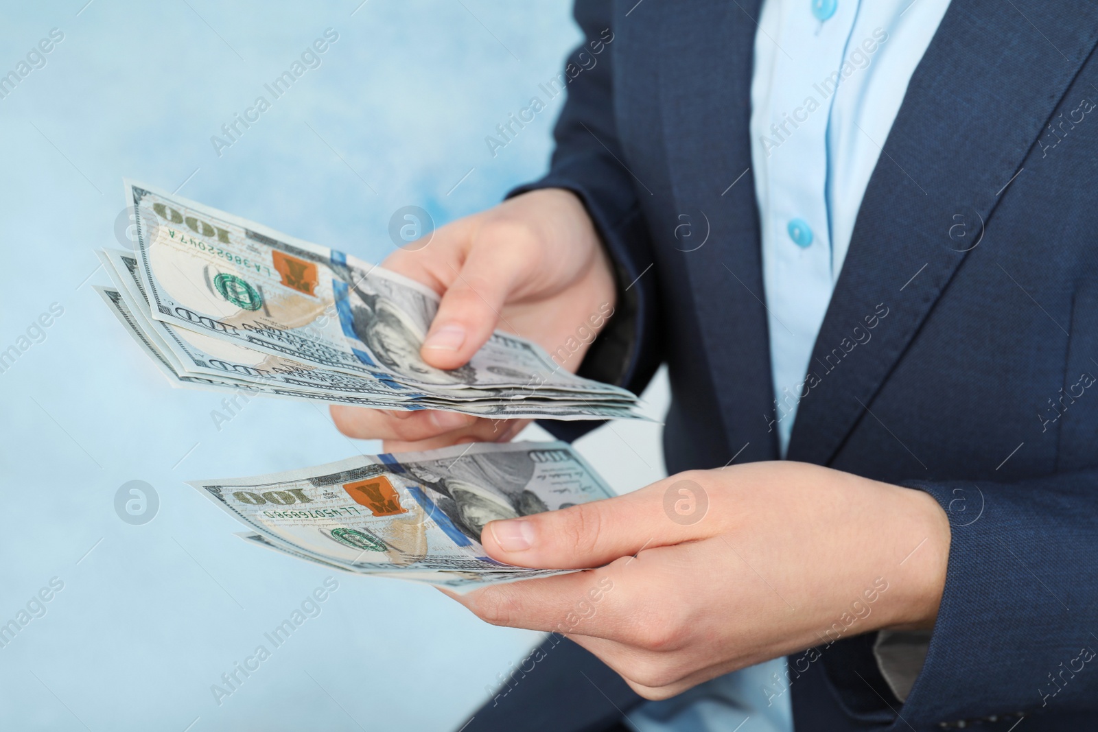 Photo of Businesswoman counting dollars on color background, closeup