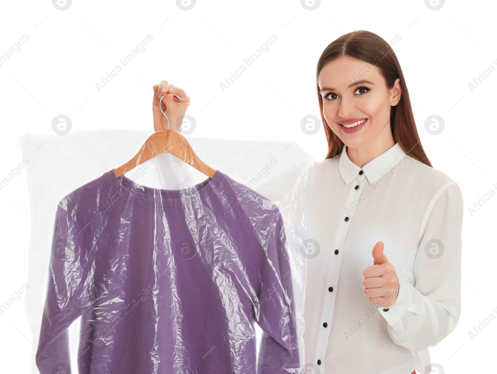 Photo of Young woman holding hanger with sweatshirt on white background. Dry-cleaning service