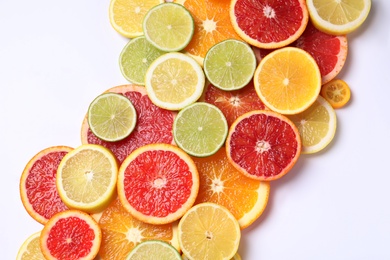 Photo of Fresh juicy citrus fruits on white background, flat lay