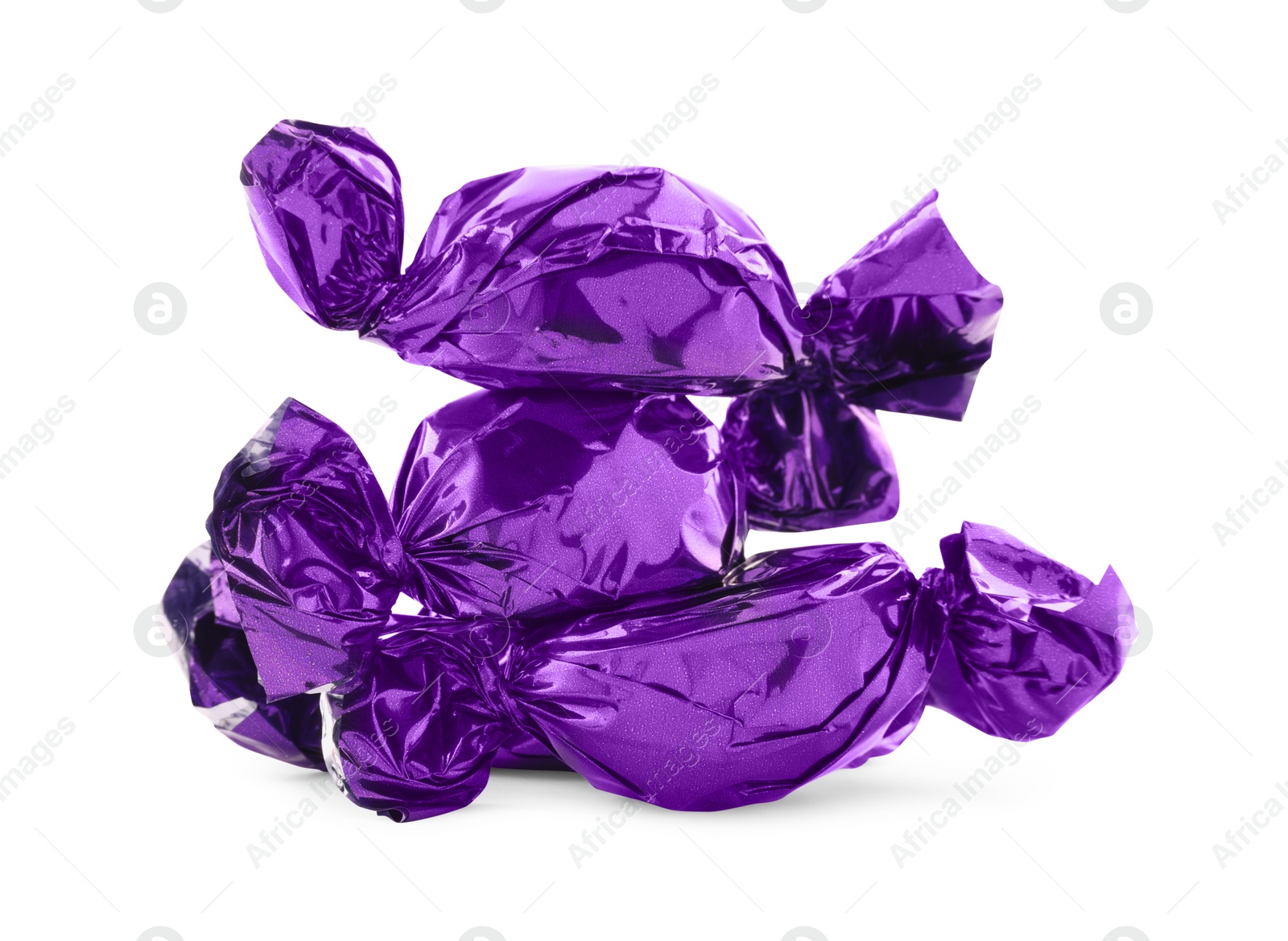 Photo of Candies in purple wrappers isolated on white