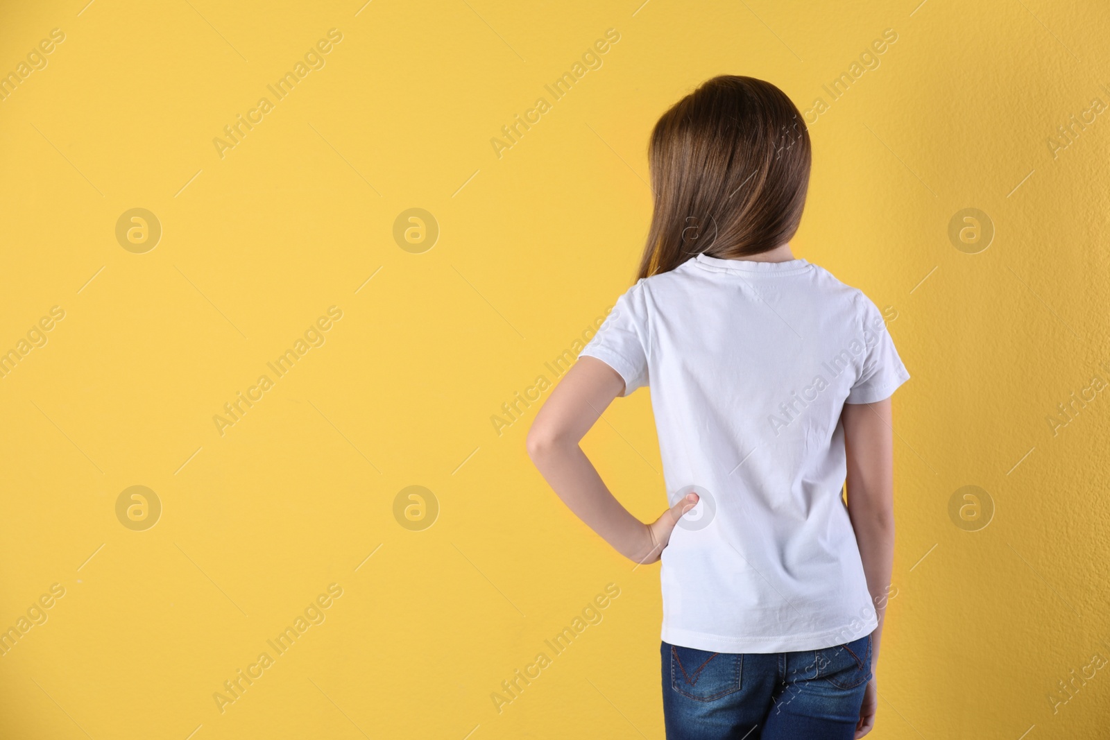 Photo of Little girl in t-shirt on color background. Mockup for design