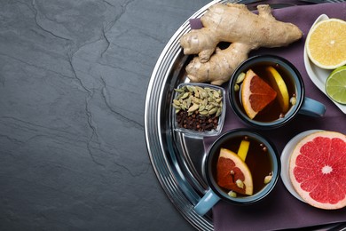 Photo of Immunity boosting drink and ingredients on black table, top view. Space for text