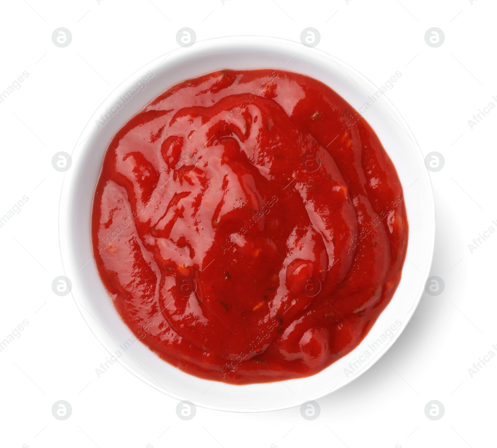 Photo of Bowl with red sauce isolated on white, top view