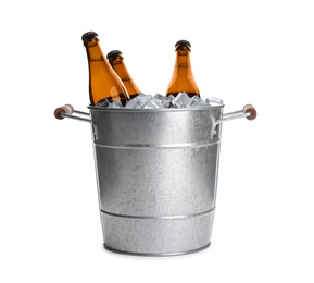 Photo of Metal bucket with bottles of beer and ice cubes isolated on white