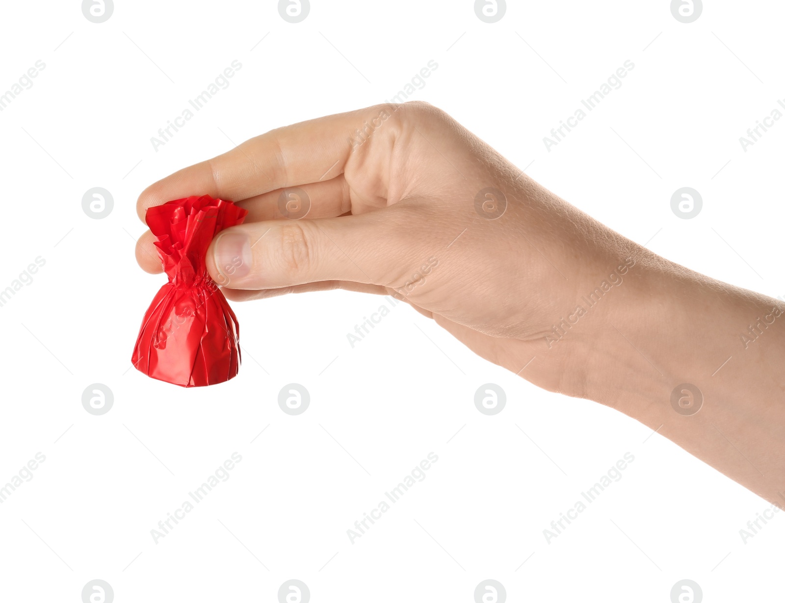 Photo of Woman holding candy in red wrapper isolated on white, closeup