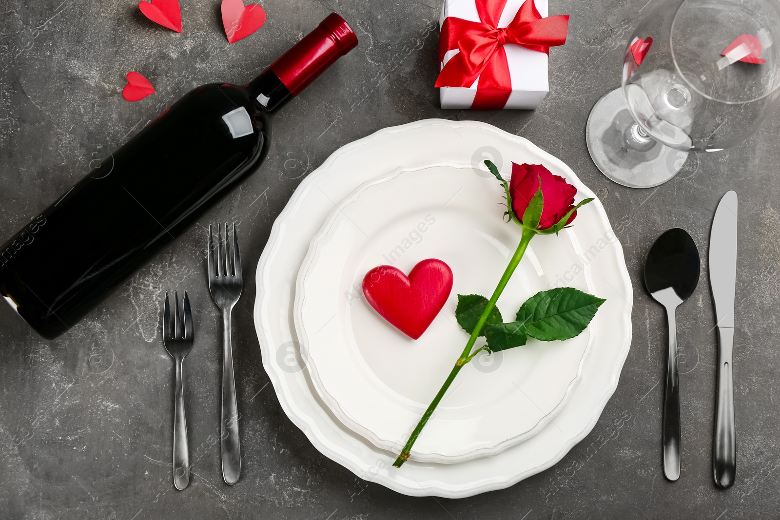 Photo of Beautiful table setting for Valentine's Day dinner on grey background, flat lay