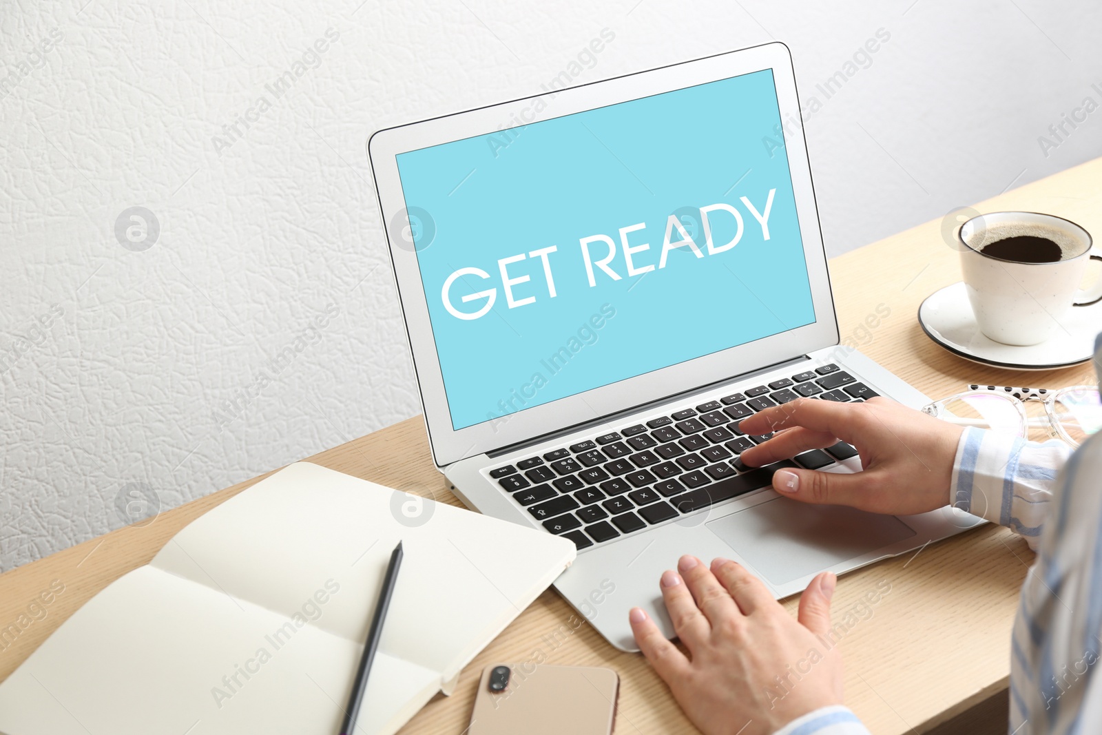 Image of Woman using laptop with phrase Get Ready at table, closeup