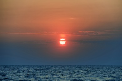 Photo of Picturesque sky with sun over sea at sunset