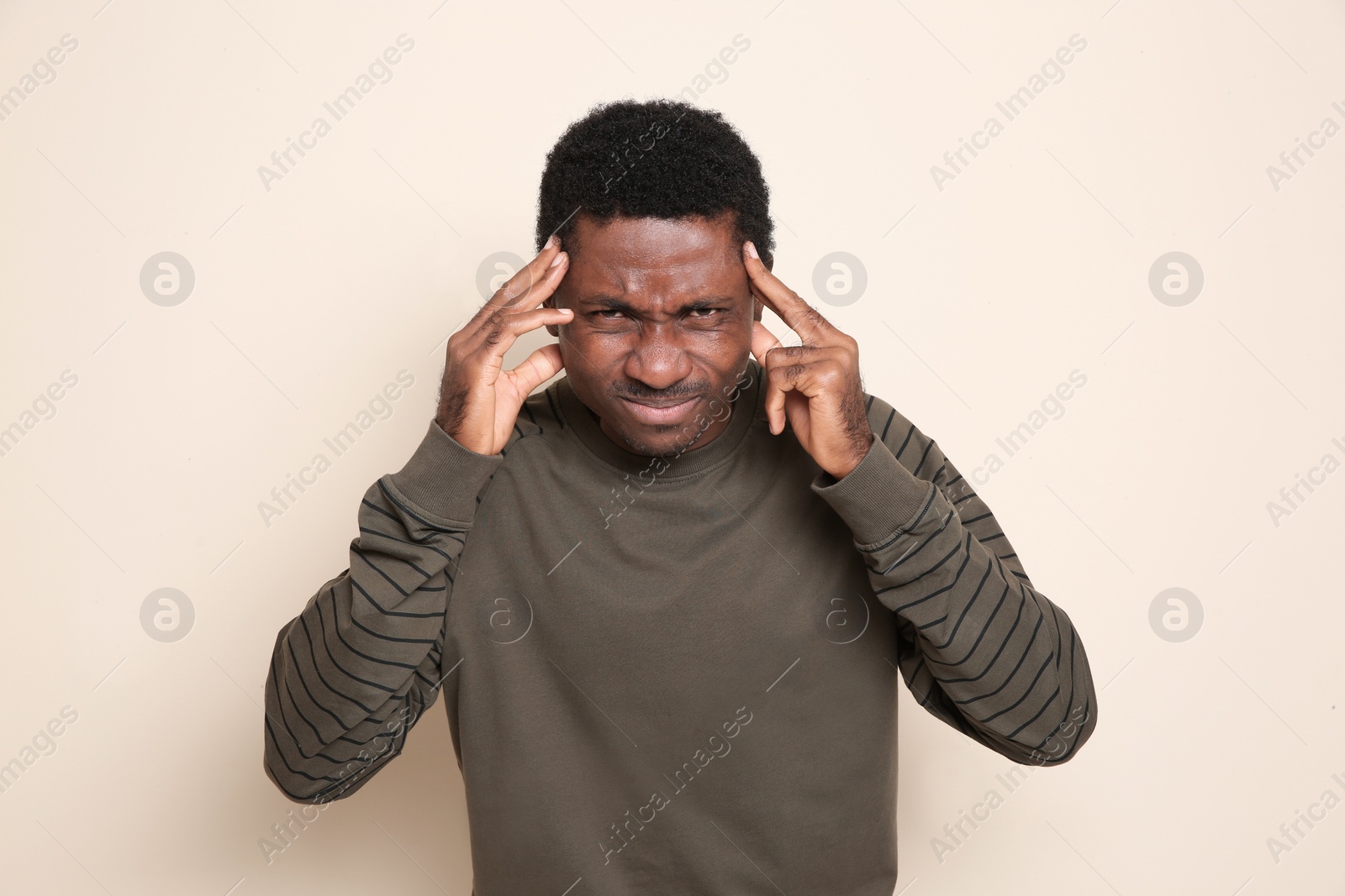 Photo of Portrait of thoughtful African-American man on color background