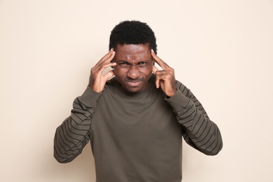 Portrait of thoughtful African-American man on color background