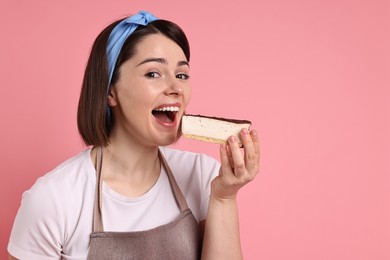 Happy confectioner eating cheesecake on pink background, space for text