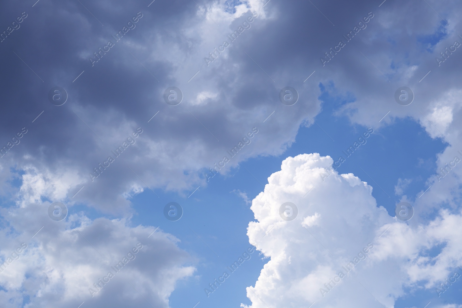 Photo of Beautiful fluffy clouds on light blue sky as background