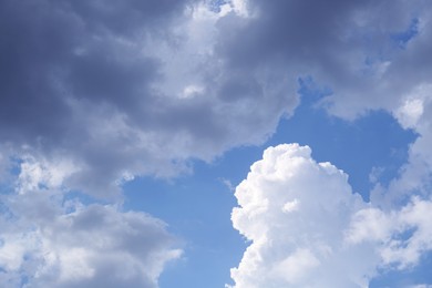 Beautiful fluffy clouds on light blue sky as background