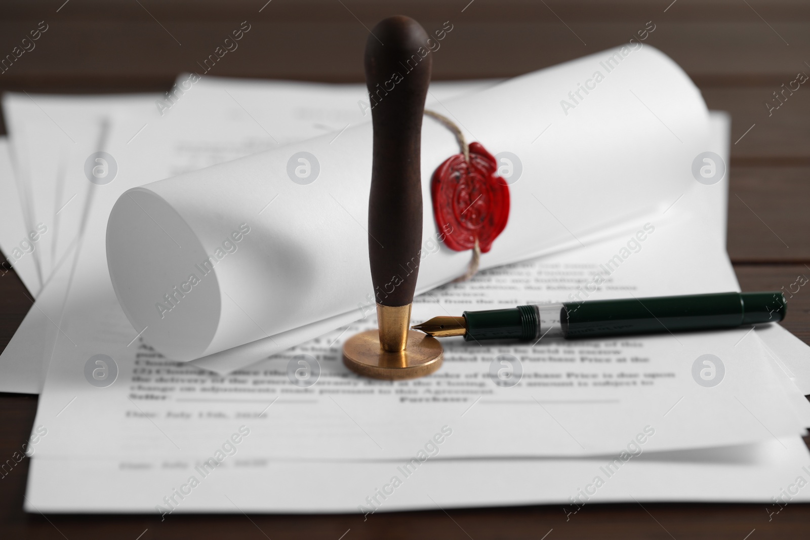Photo of Notary contract. Documents, wax stamp and pen on table