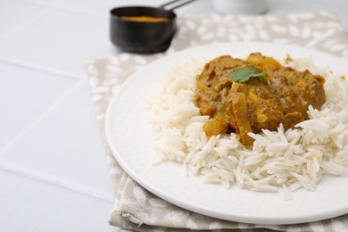 Photo of Delicious chicken curry with rice on white tiled table, closeup