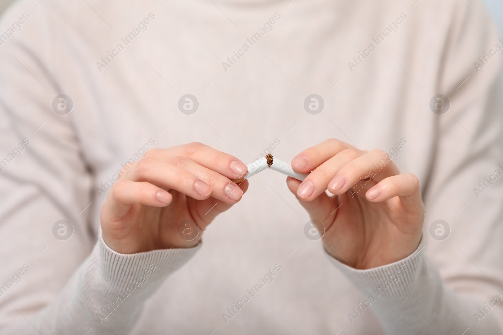 Photo of Stop smoking concept. Woman breaking cigarette, closeup