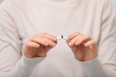 Photo of Stop smoking concept. Woman breaking cigarette, closeup