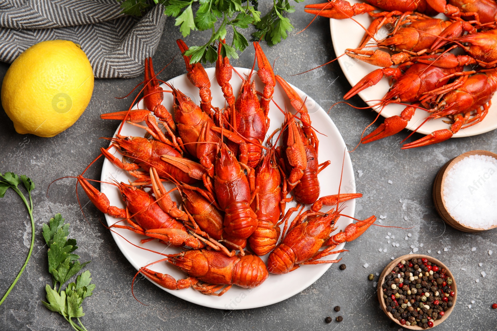 Photo of Flat lay composition with delicious boiled crayfishes on grey table