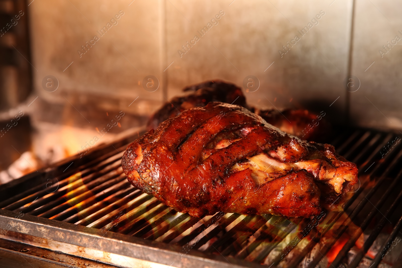Photo of Grilling grate with pork foreshanks in oven