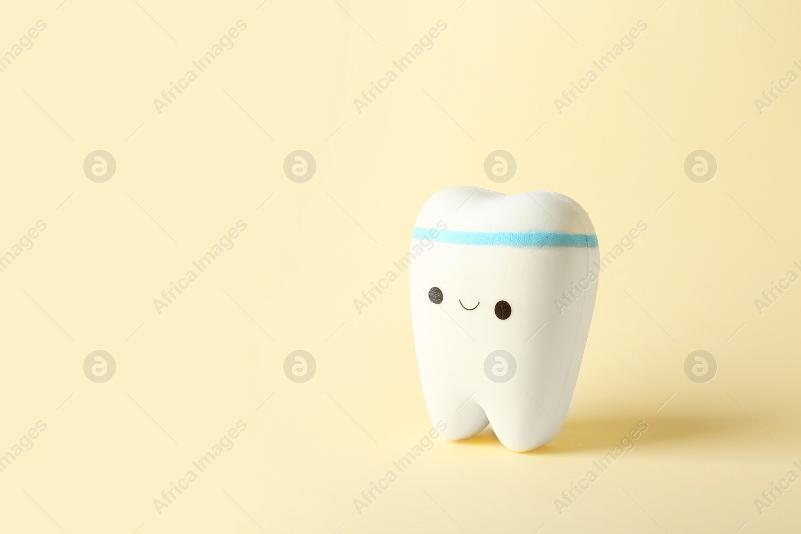 Photo of Model of tooth with happy face and space for text on color background