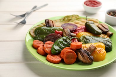 Delicious grilled vegetables on white wooden table, closeup